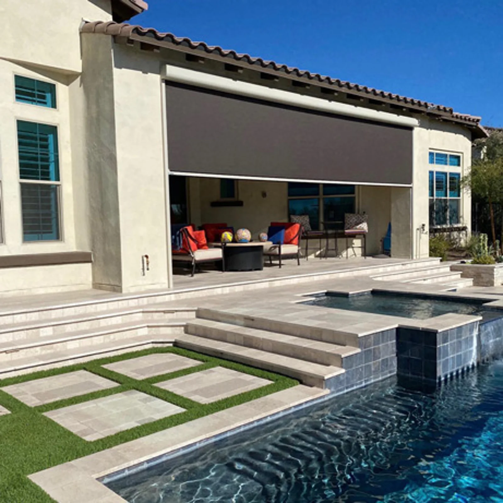 Fenetex motorized shade screen partially lowered over a residential patio